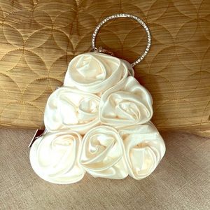 NWT triangular satin clutch with rosettes